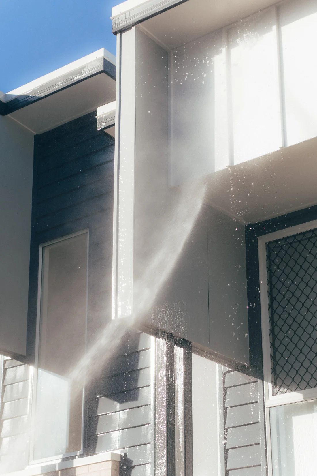 Controlled soft washing on a modern home exterior