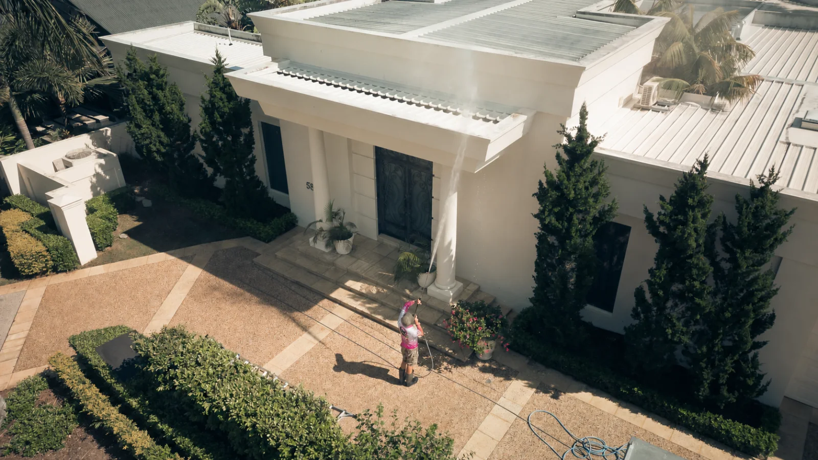 Koala Pressure Washing technician in uniform washing a Sunshine Coast home